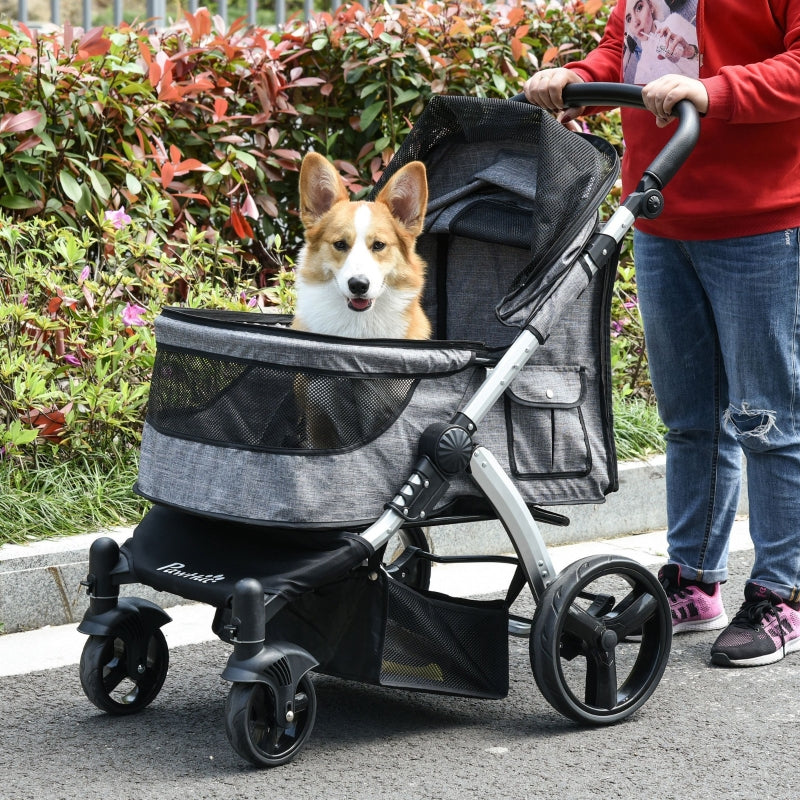 Travel pet stroller with gray fabric canopy and black mesh sides, seen with pet inside