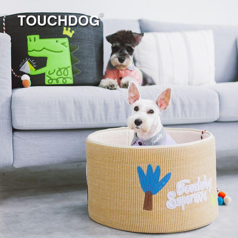 Khaki rounded scratching cat bed with white dog sitting inside; teaser toy visible