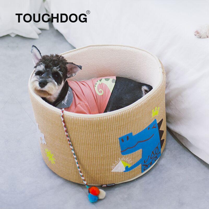 Khaki rounded scratching cat bed with small dog inside; teaser toy hanging