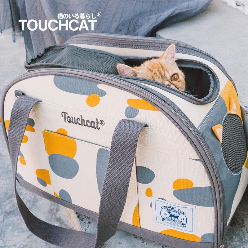 Blue-and-white patterned cat carrier with open top and front label patch