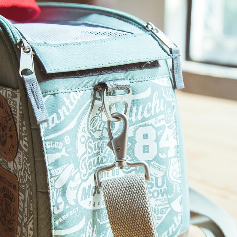 Light blue pet carrier duffel with front zipper pocket and brown leather-style patch