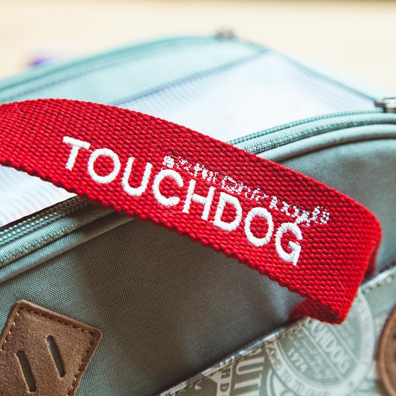 Red webbing strap with white “Touchdog” lettering on a pet carrier