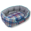 Blue plaid oval dog bed with gray interior and light blue trim