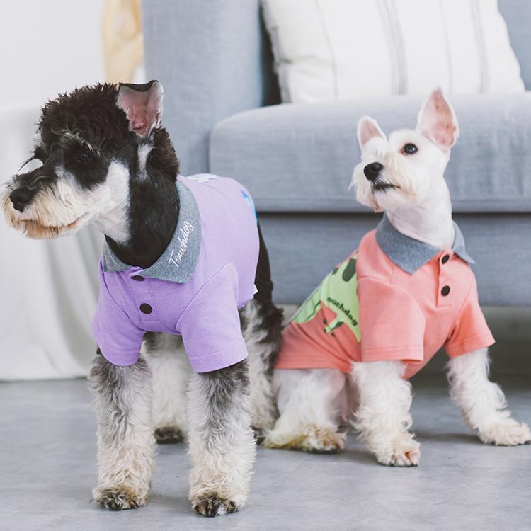 Lavender and peach dog polo shirts with gray collars, button plackets, worn by two dogs
