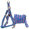 Blue dog harness with bone-themed pattern, padded straps, and metal leash clip