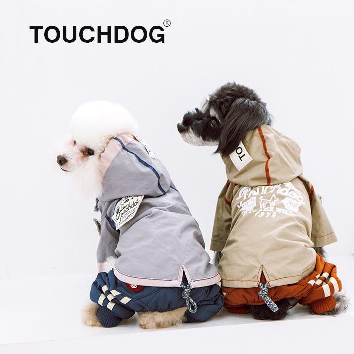 Two small dogs wearing hooded reversible raincoats: light gray and tan/khaki sides