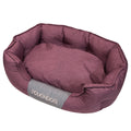 Pink oval dog bed with padded sides and cushioned base, water-resistant fabric