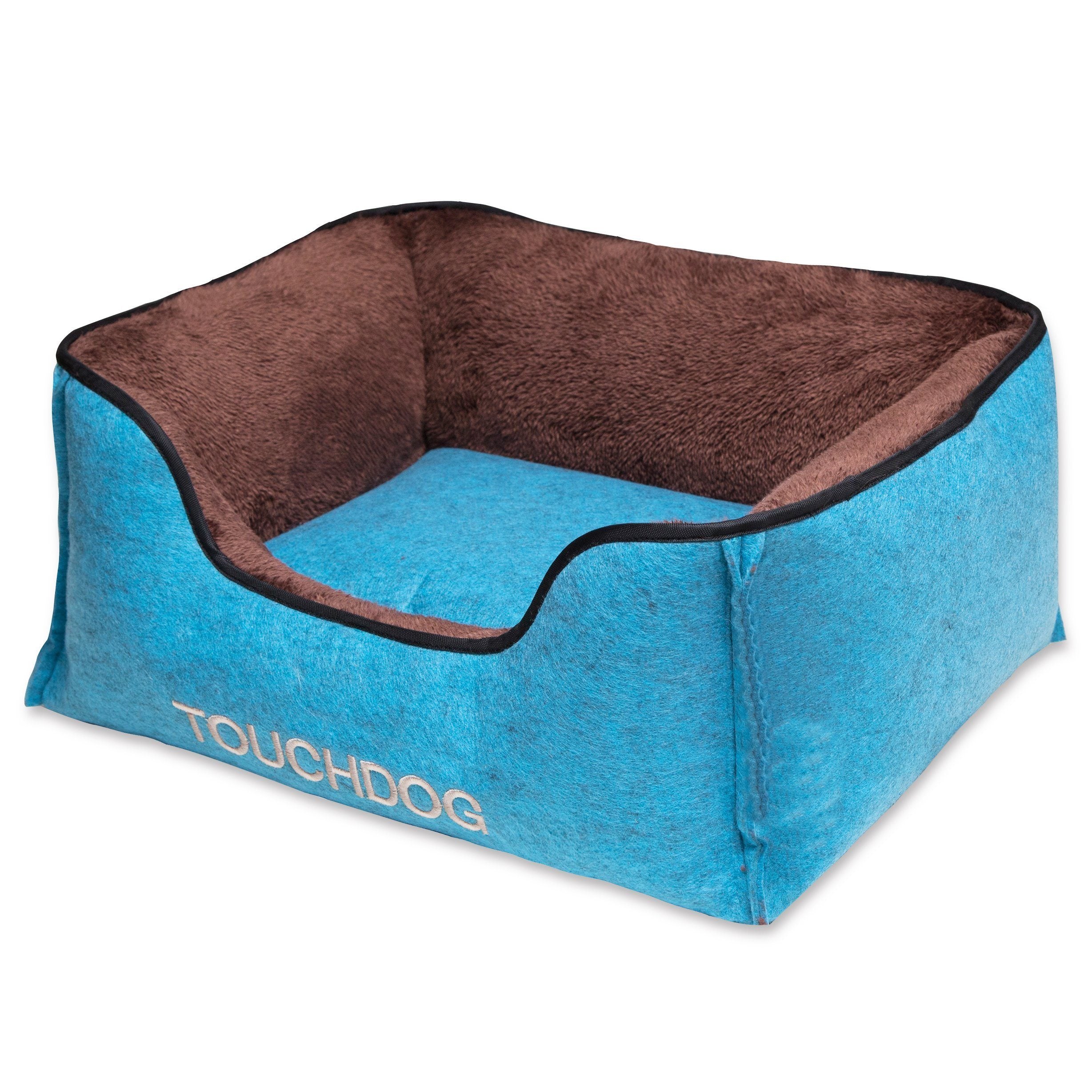 Luxury dog bed with blue exterior, dark brown inner cushion and black-trim edge