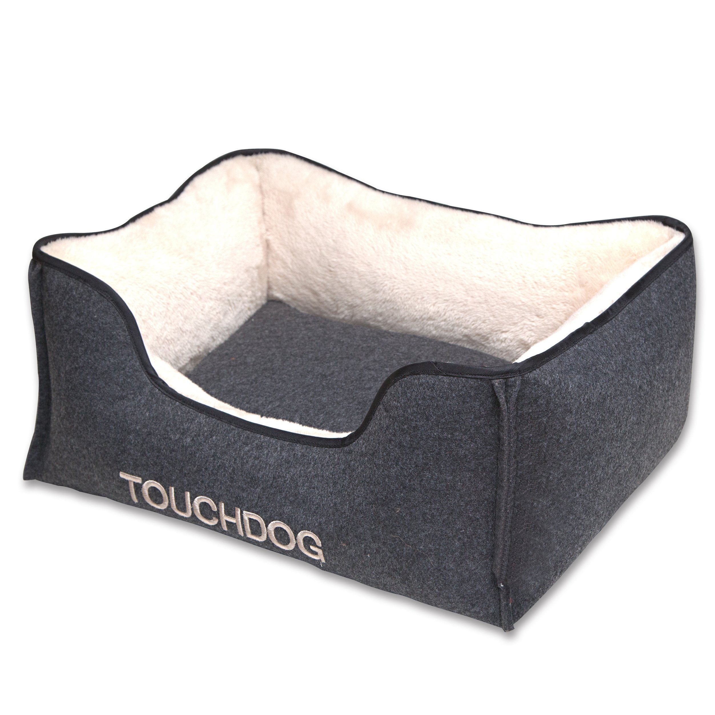 Luxury dog bed with gray exterior, white inner lining and dark cushion center