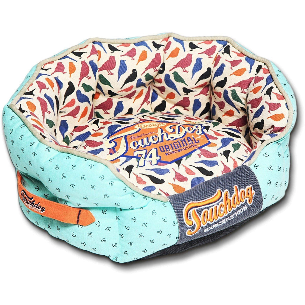 Light blue rounded dog bed with bird-print interior and front “Touchdog” badge label