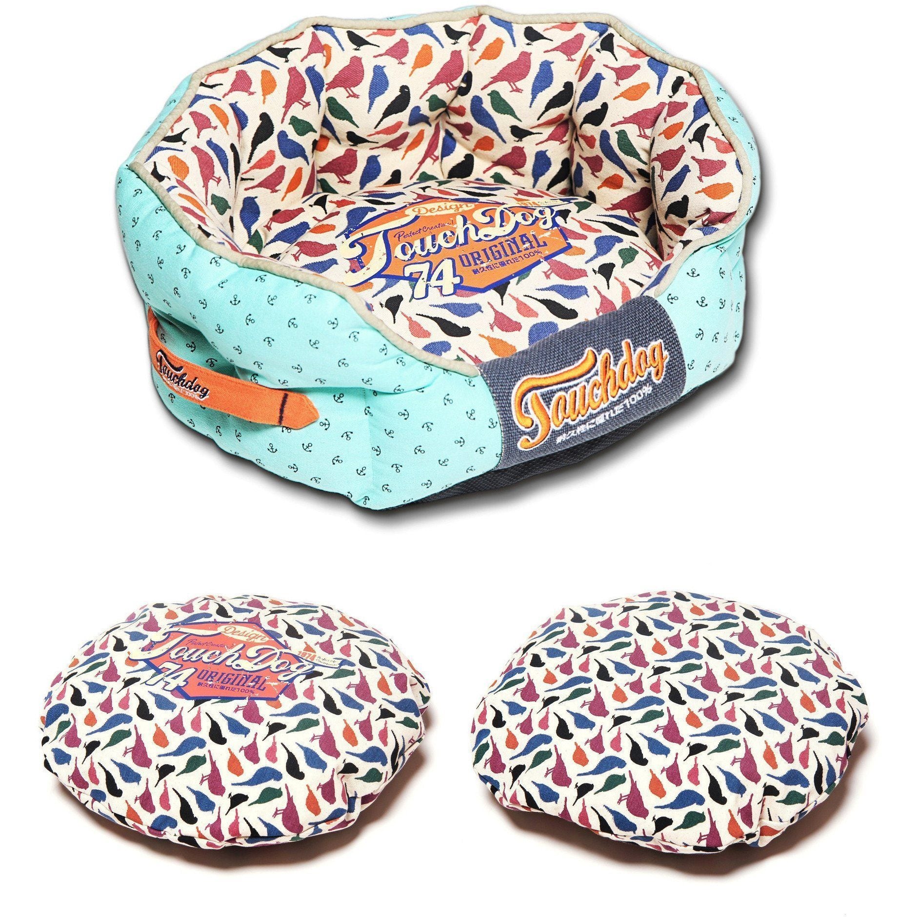 Rounded dog bed with light blue outer fabric, bird-print center, “Original 74” label