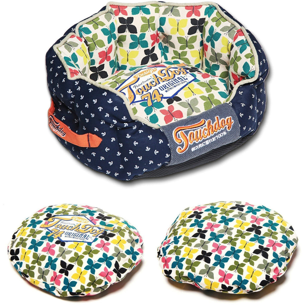 Navy rounded dog bed with butterfly print interior and “Original 74” label on cushion