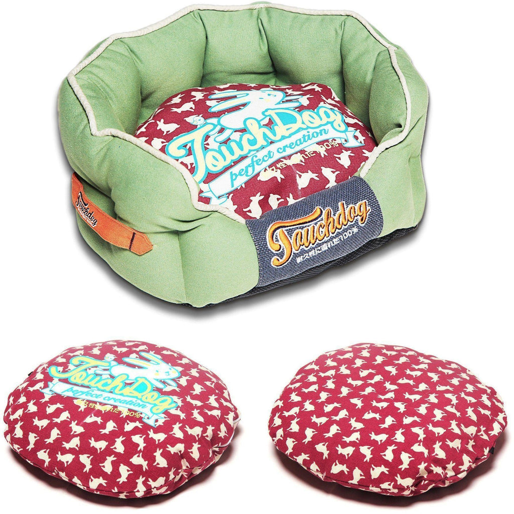 Green rounded dog bed with red rabbit-spotted cushion and navy logo trim