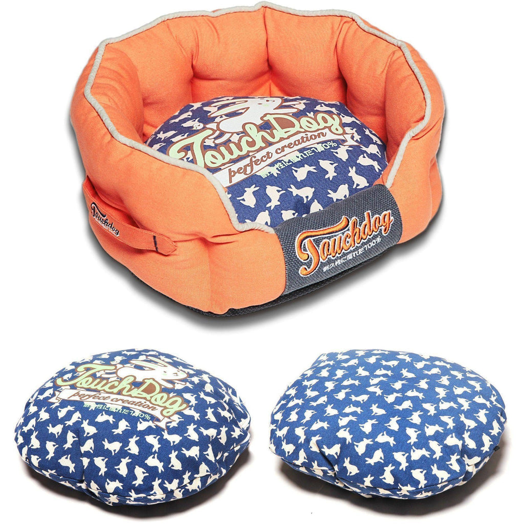 Orange rounded dog bed with navy rabbit-pattern cushion; matching extra cushion shown