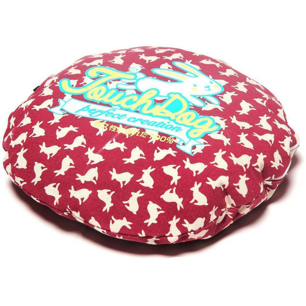 Red rabbit-spotted dog bed cushion with “Perfect creation” lettering