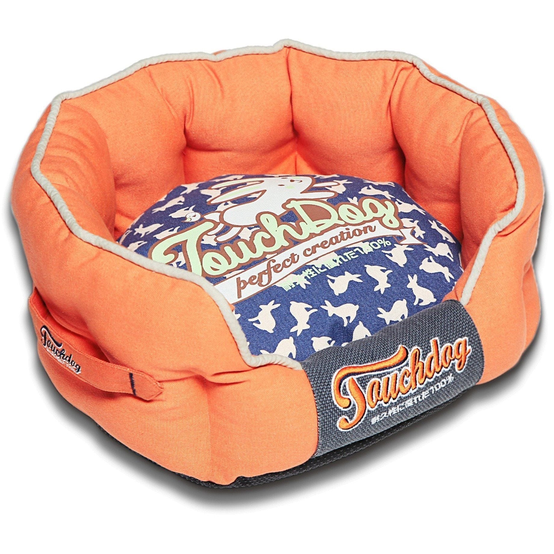 Orange and navy rounded dog bed with rabbit-spotted cushion and cushioned bolster