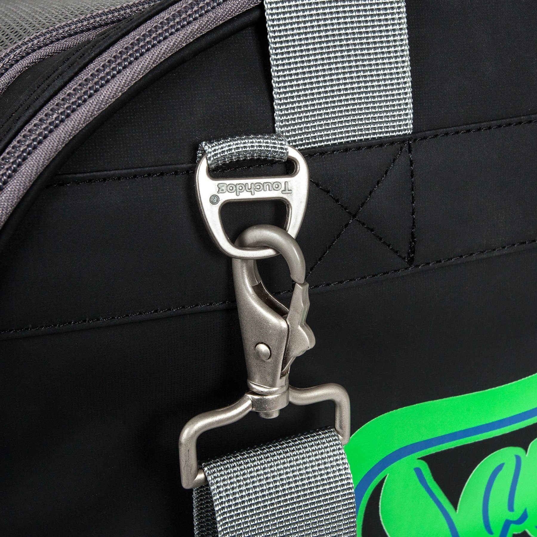 Black dog carrier close-up with metal D-ring clip and gray shoulder strap
