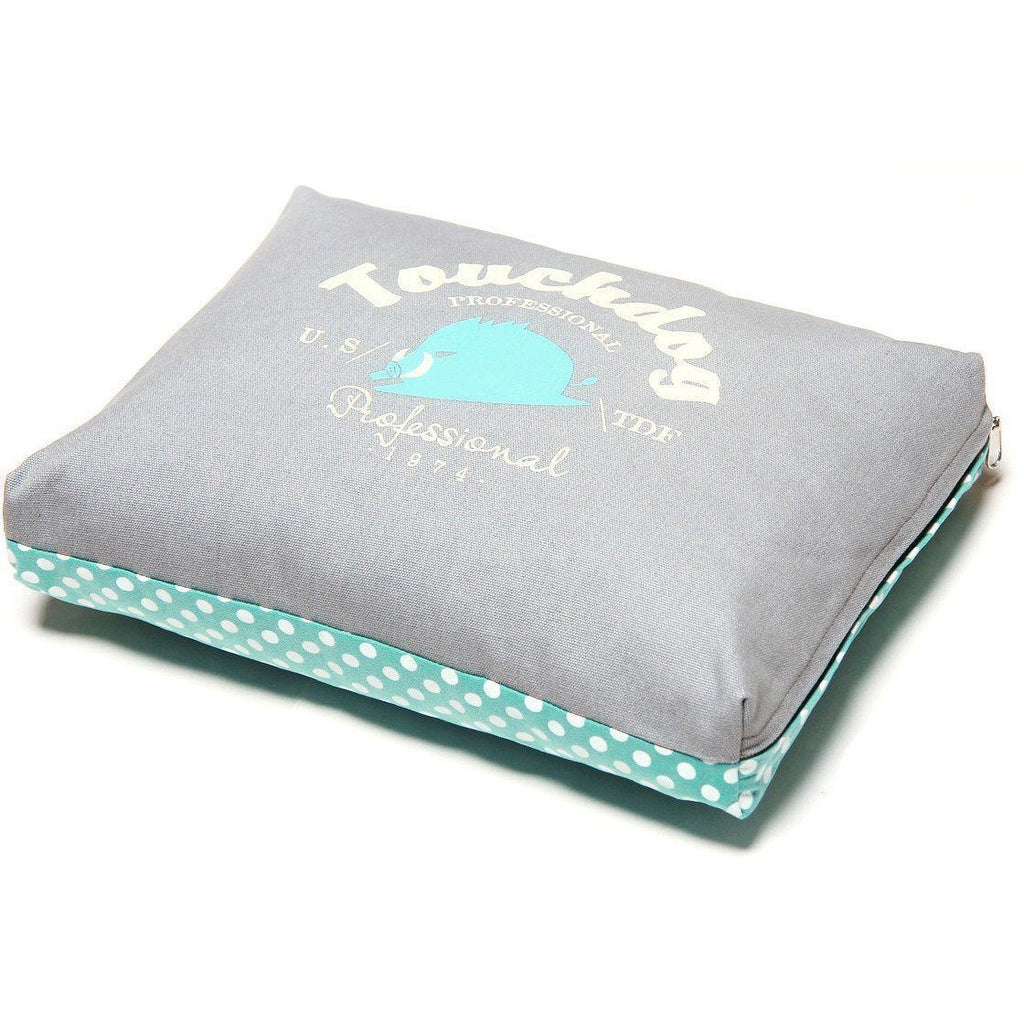 Gray rectangular dog bed cushion with teal polka-dot base lining