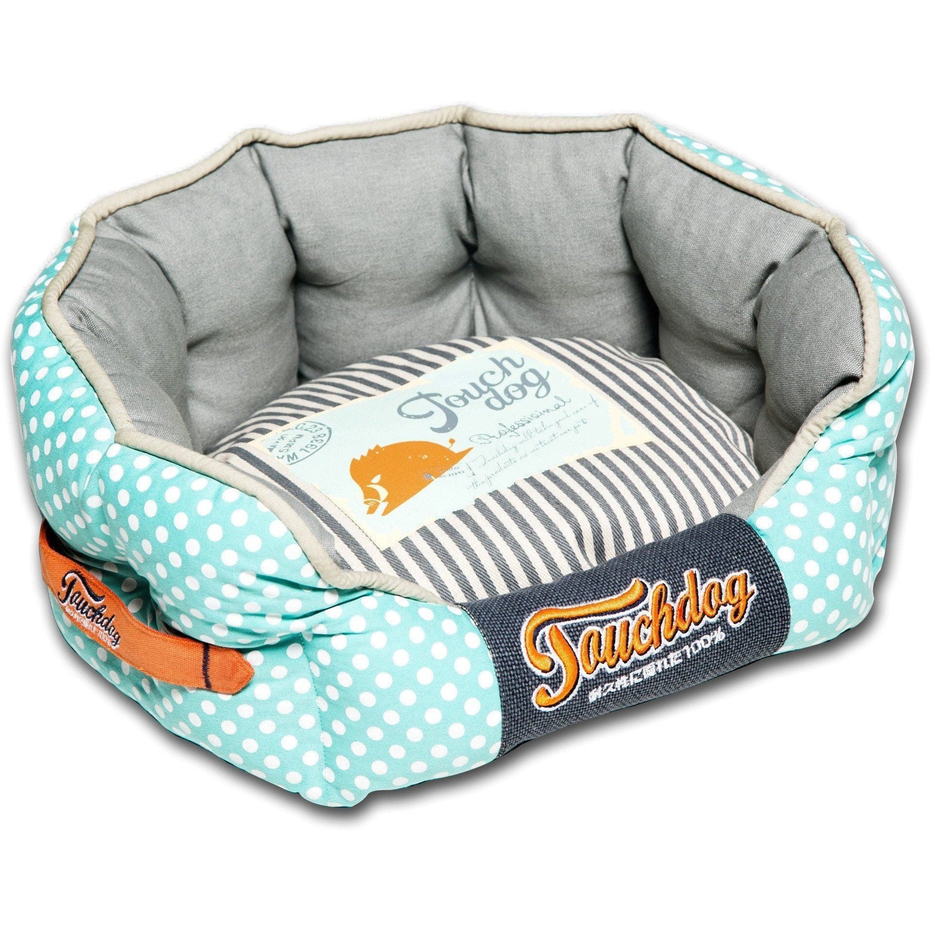Rounded dog bed with turquoise polka-dot sides, gray cushioned interior, striped insert