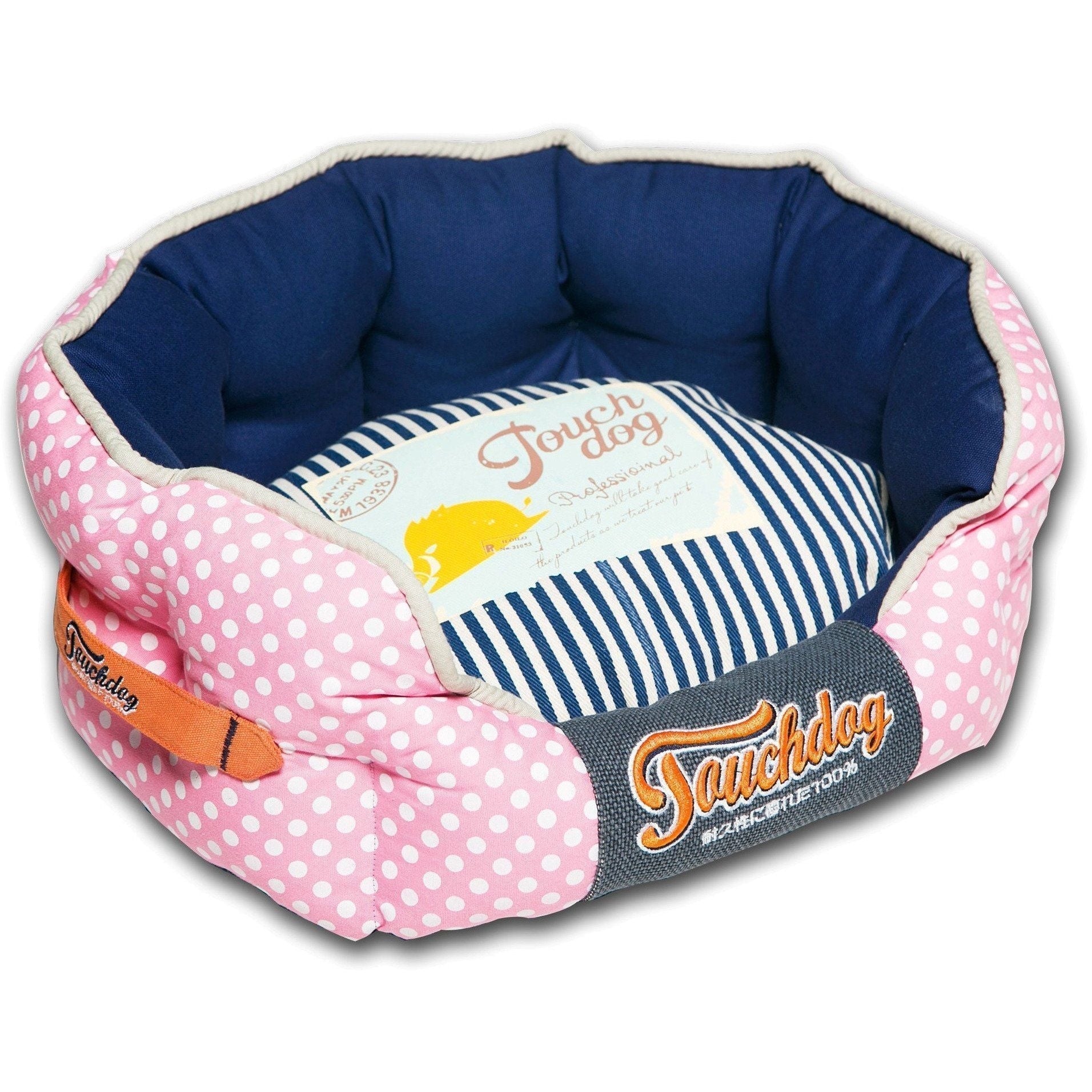 Rounded dog bed with pink polka-dot sides, navy interior, striped pad, Touchdog front logo