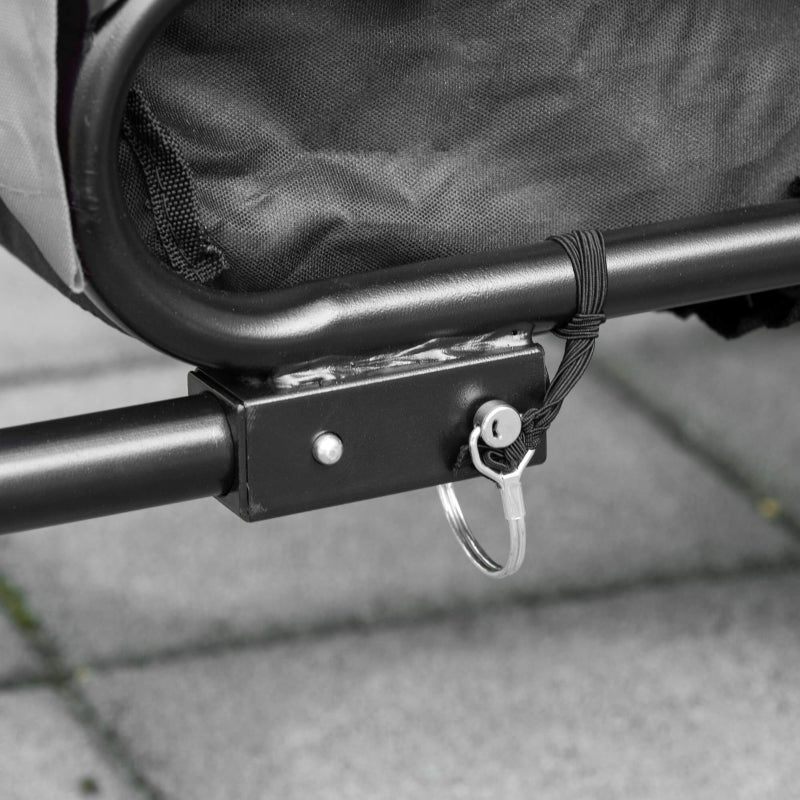 Metal hitch joint of a grey pet bike trailer stroller with safety tether and black frame bar