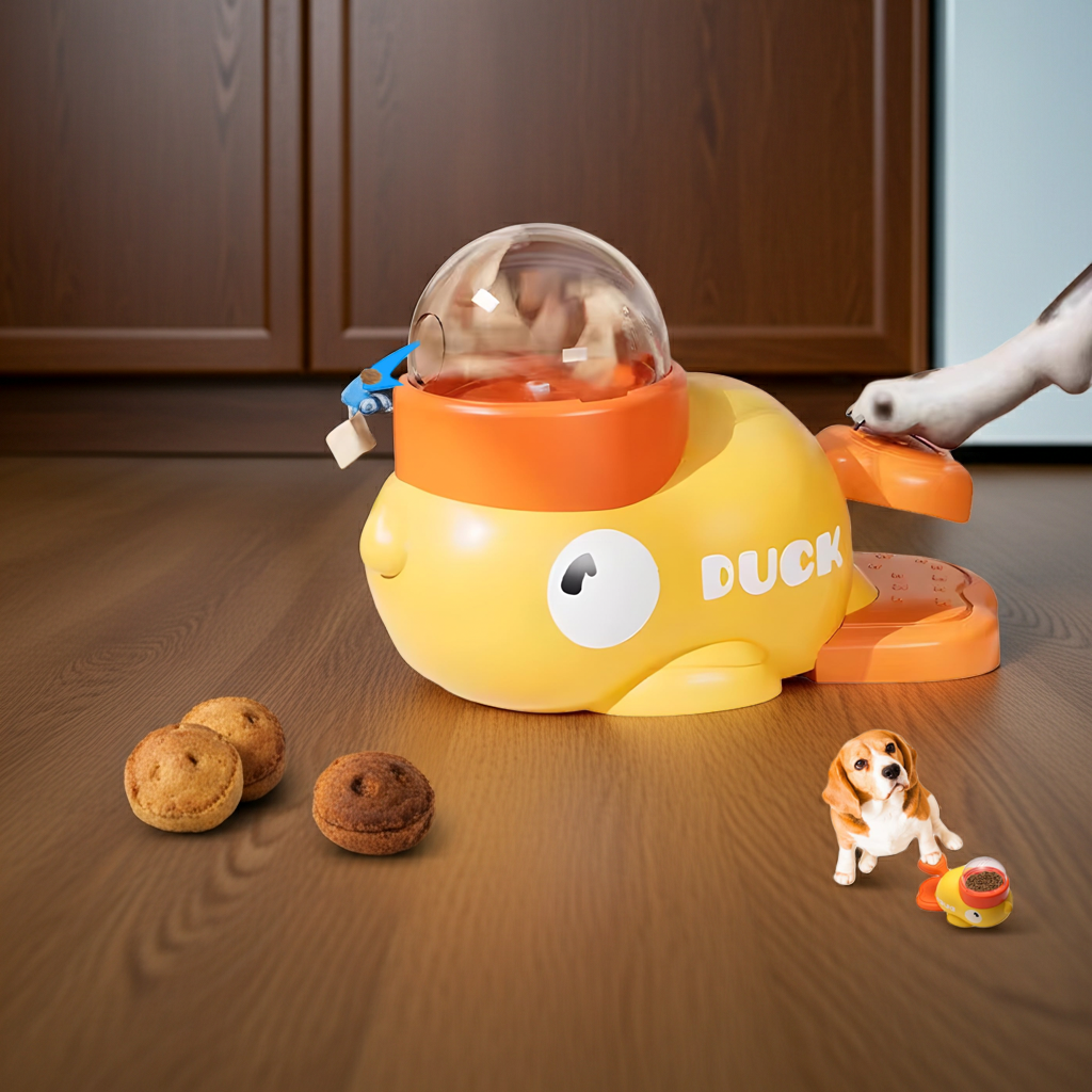 Duck-shaped dog treat dispenser toy with yellow body and orange clear dome lid
