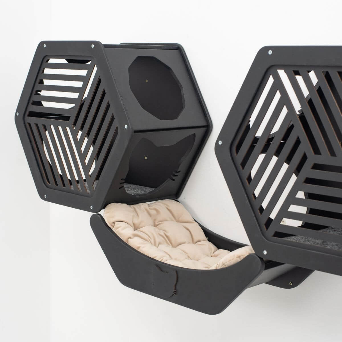 Hexagonal wall cat bed in black with slatted sides and beige cushion