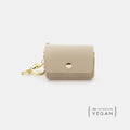 Beige vegan leather waste bag holder with snap button and gold keyring clip