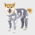 Gray fleece dog jumpsuit pajamas with white bone pattern, hoodless front and back legs